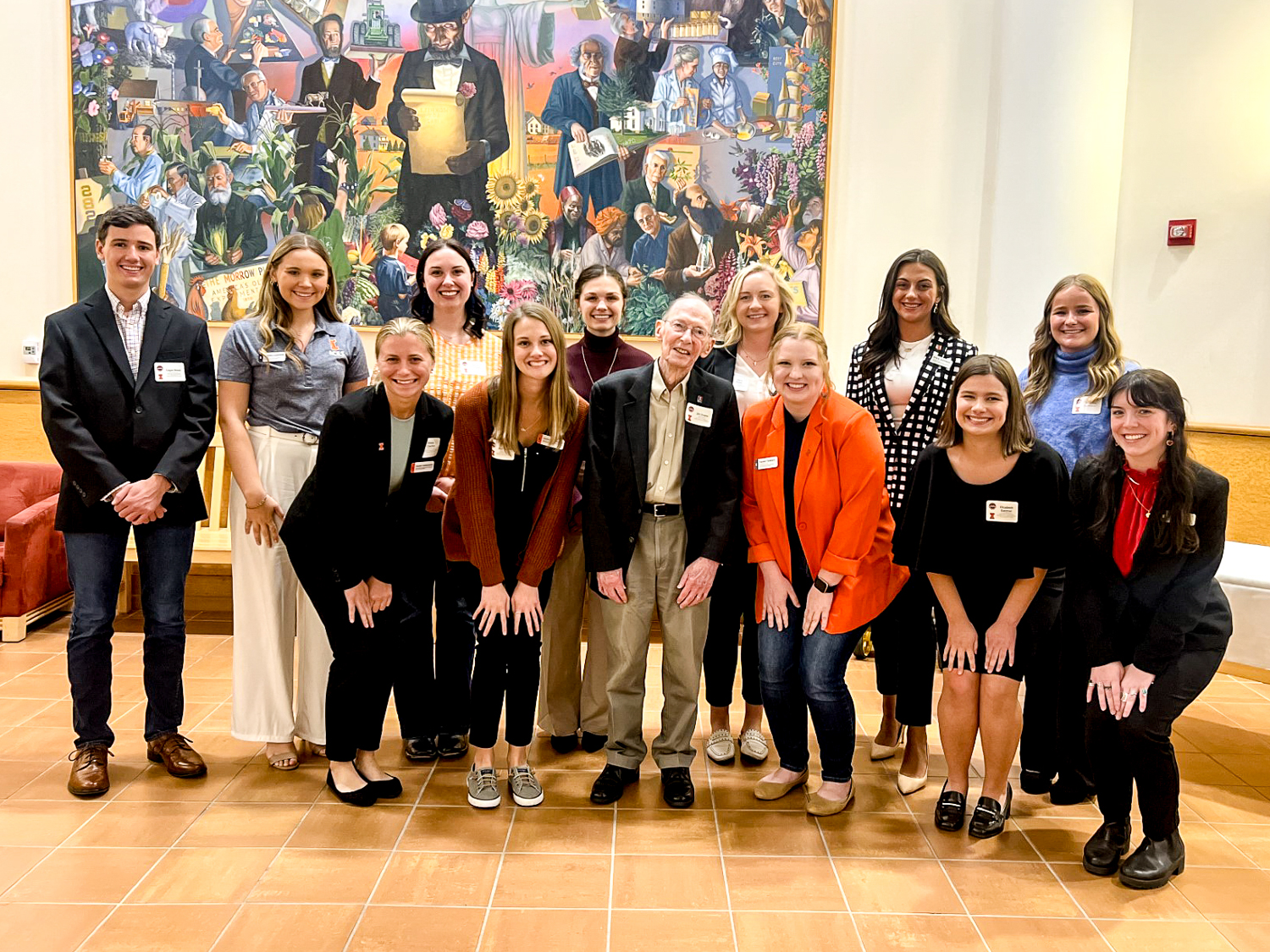 Jim Evans and a group of students pose in front of the large Abraham Lincoln painting in the ACES Funk Library.